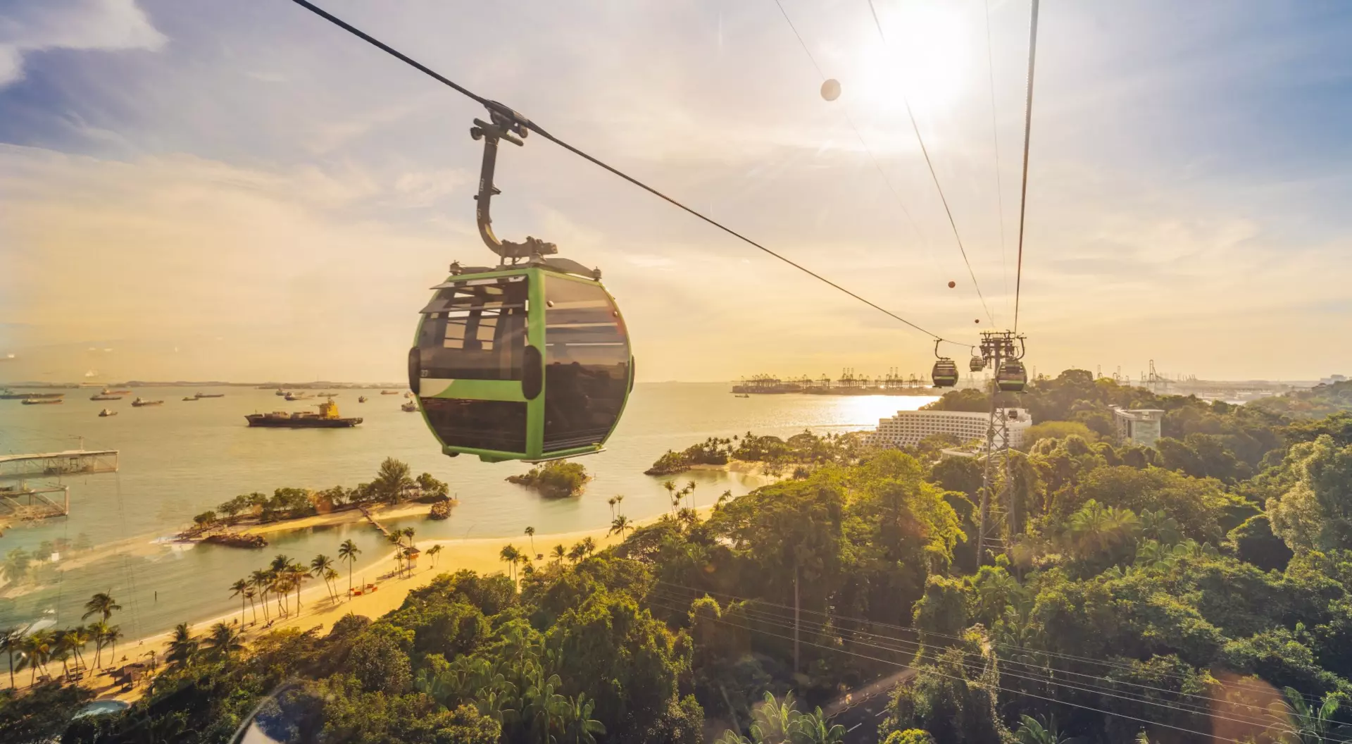 Sentosa Island Cable car trip to Sentosa Island, Singapore. Aerial view showing lush green forest and sandy beach below