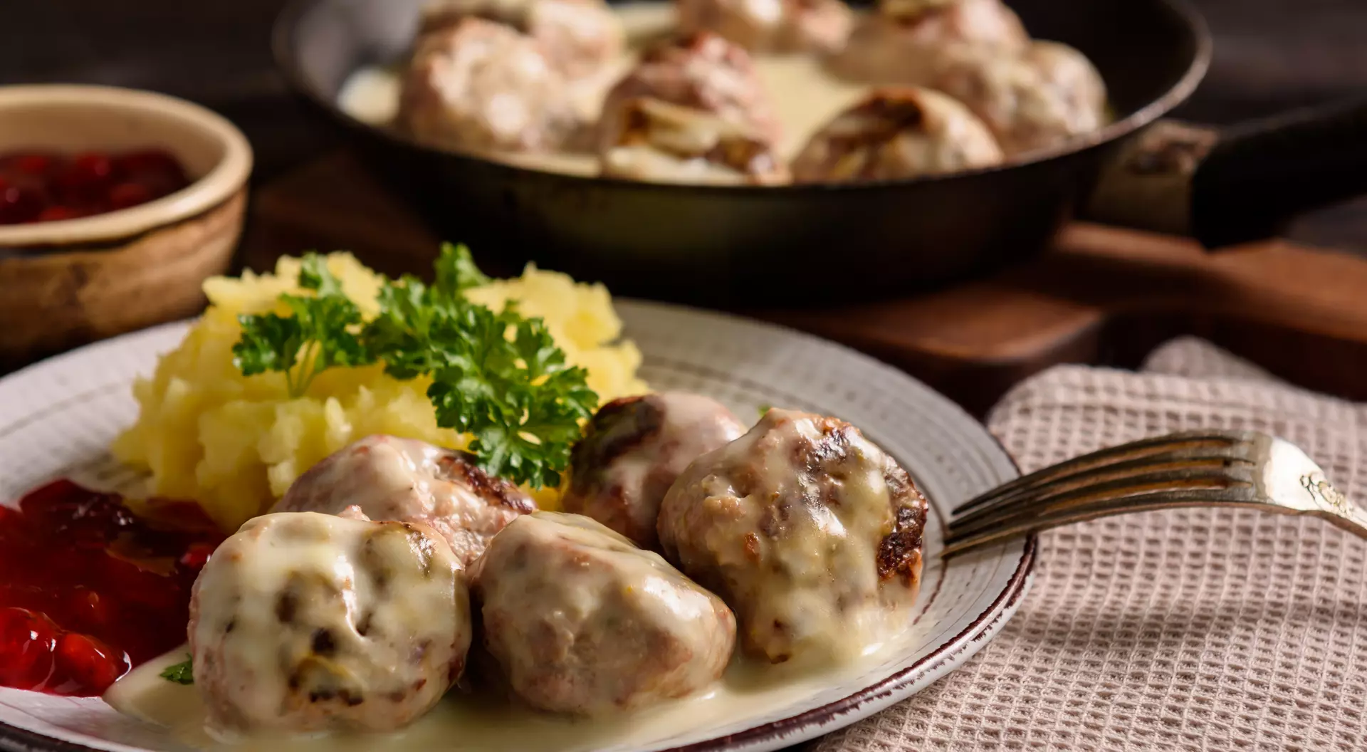 Sweden Swedish meatballs with creamy gravy, mashed potatoes and lingonberry sauce.