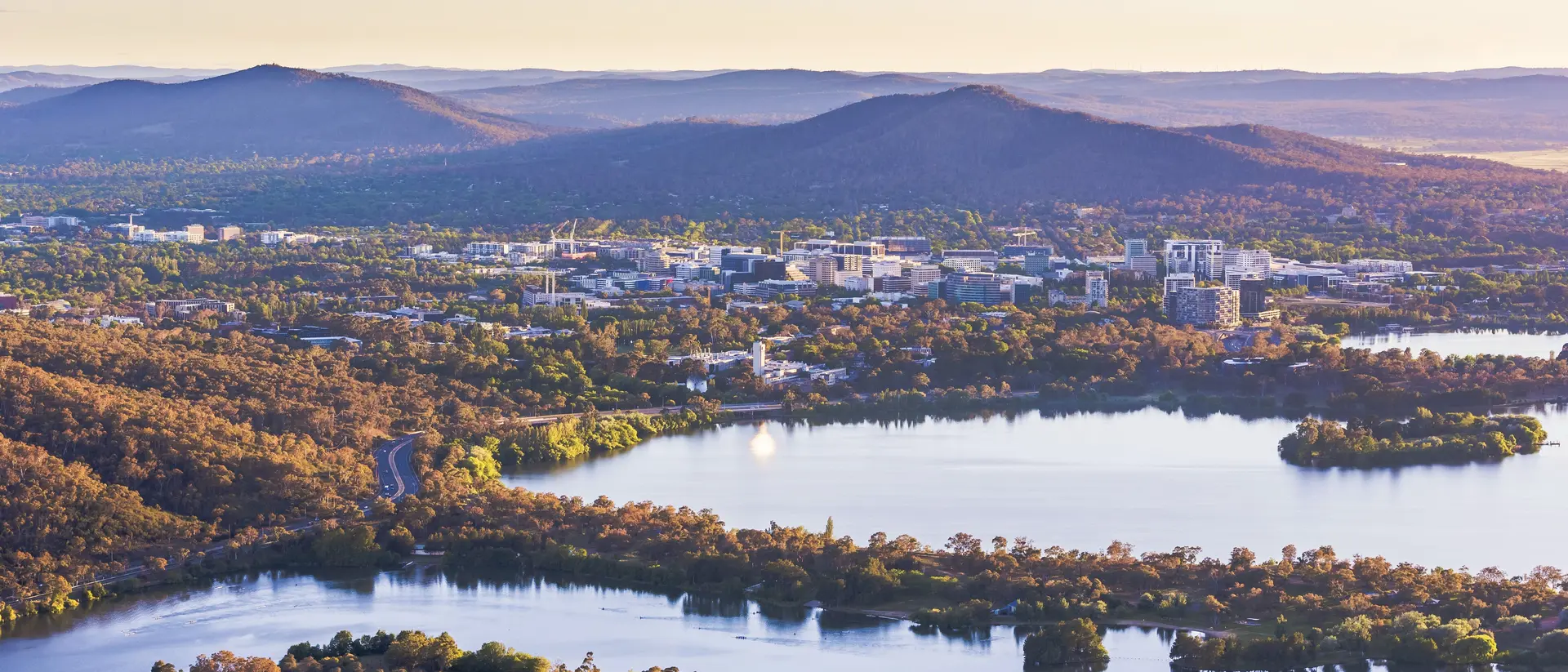 Aerial view of Canberra Central Business District with sunrise at Lake Burley Griffin