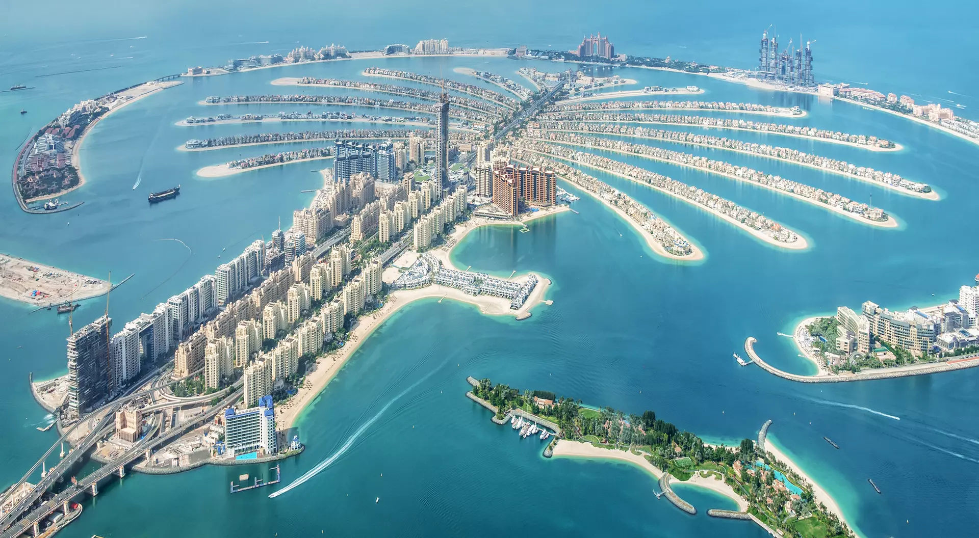 Aerial view of Palm Jumeirah, Dubai, featuring its palm-shaped islands and surrounding turquoise waters.