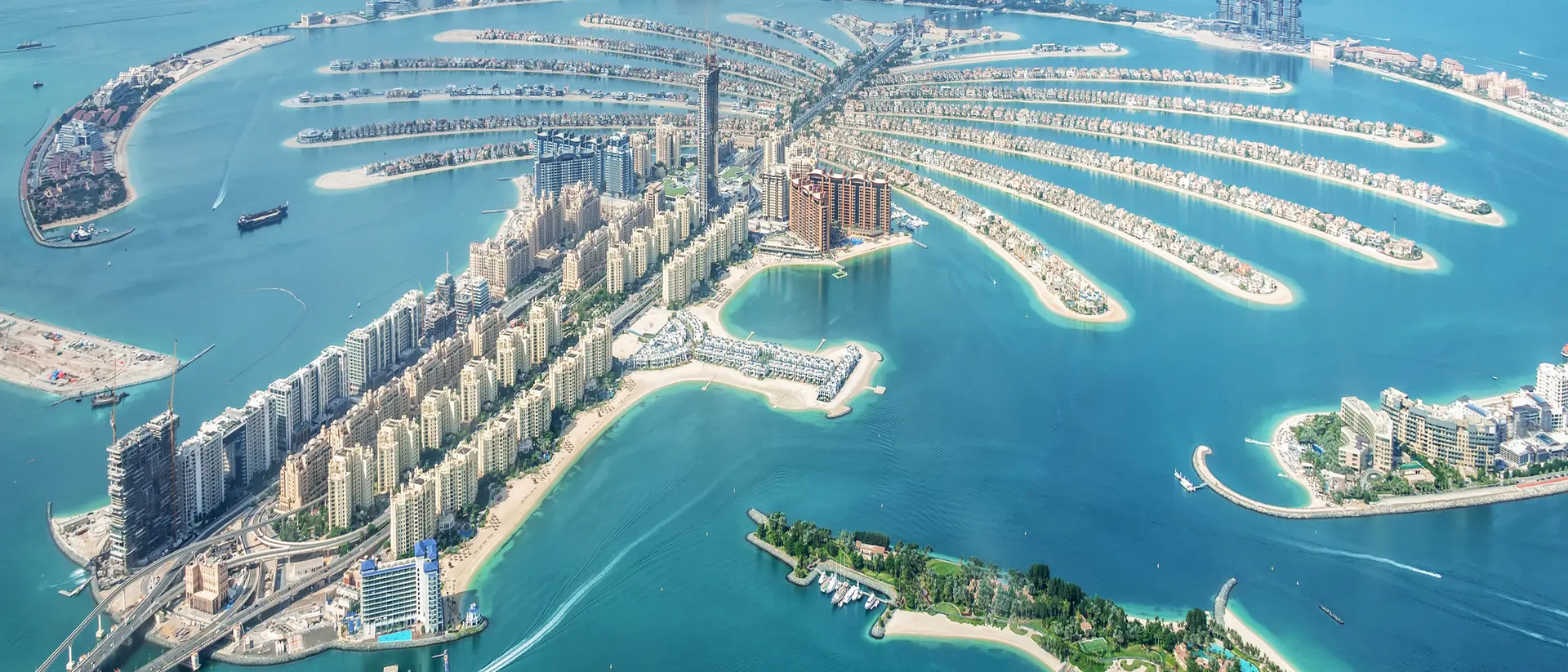 Aerial view of Palm Jumeirah, Dubai, featuring its palm-shaped islands and surrounding turquoise waters.