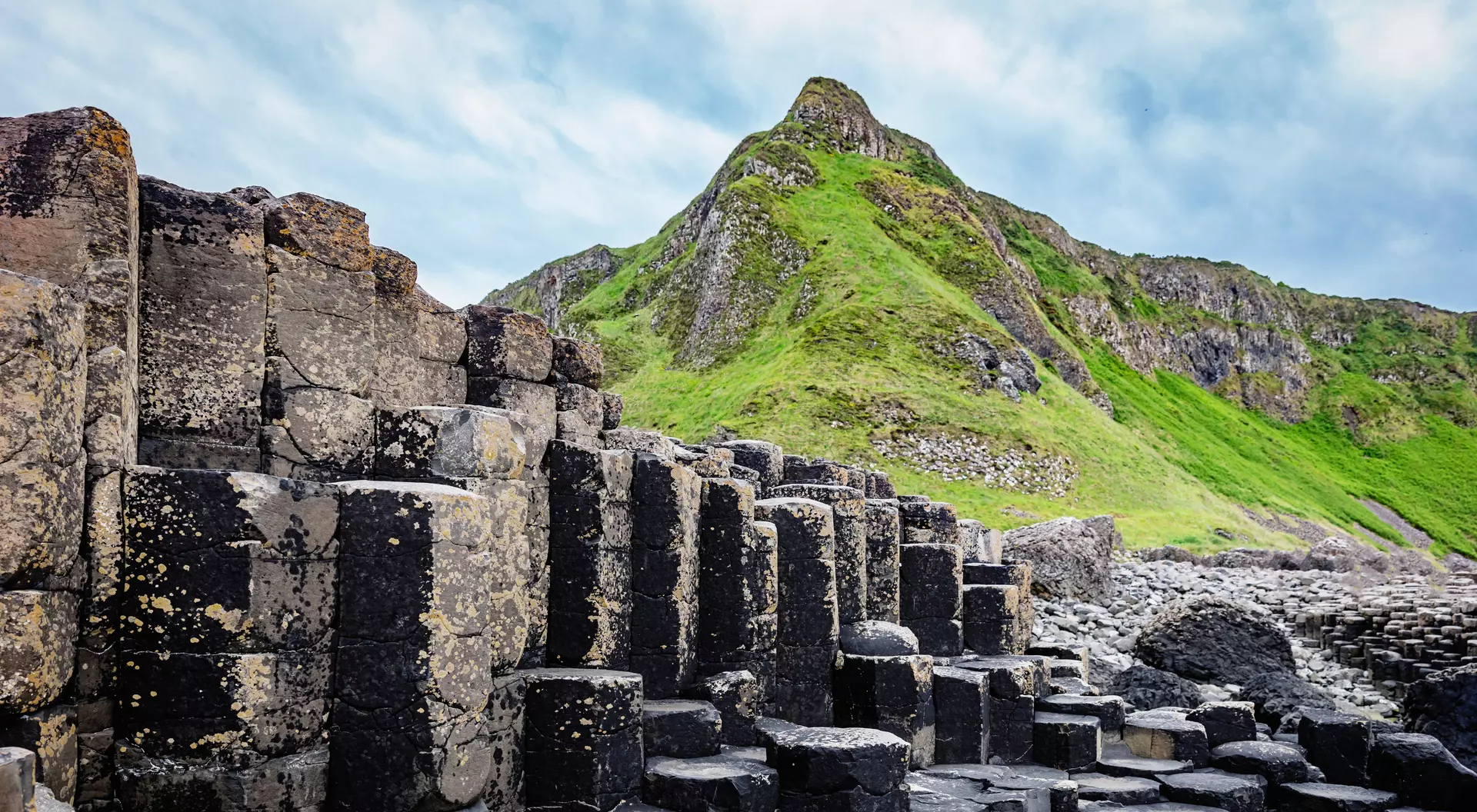 Beautiful Giants Causeway Volcanic Landscape with famous Hexagonal Basalt Columns under dramatic skyscape