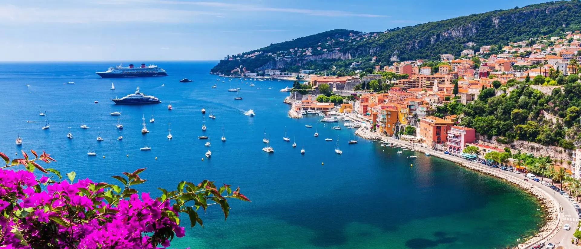 Aerial view of the vibrant town and beach with boats in the water