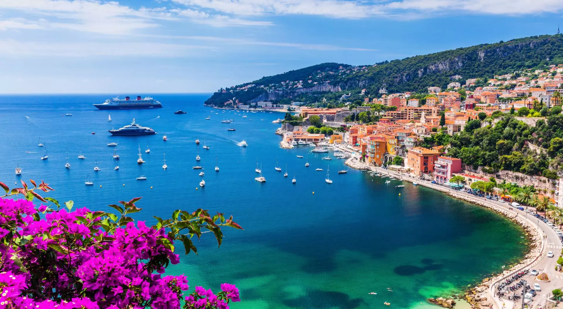 Aerial view of the vibrant town and beach with boats in the water