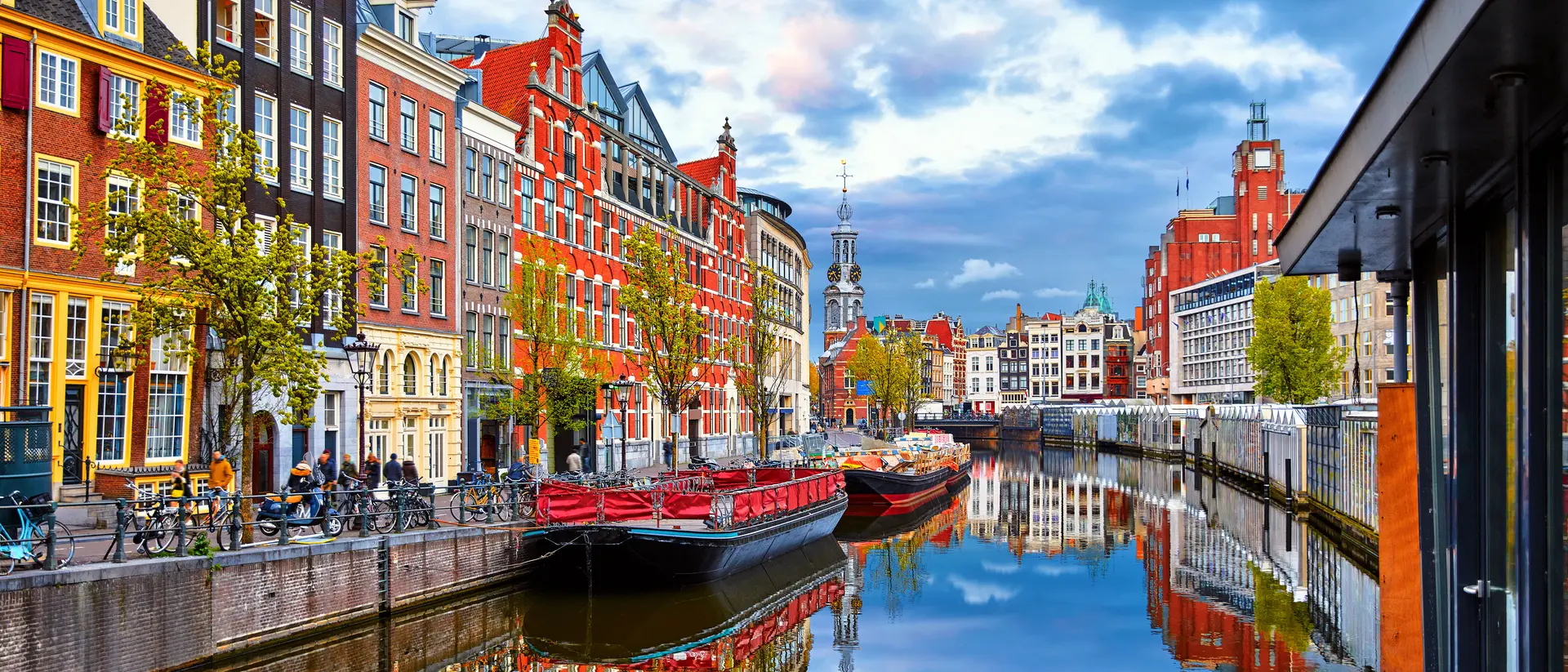 Channel in Amsterdam Netherlands houses river Amstel landmark old european city spring landscape.