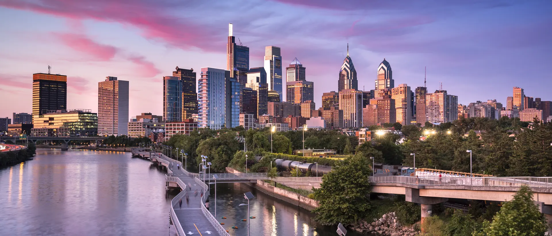 Philadelphia, United States Downtown city skyline over the Schuylkill River and boardwalk