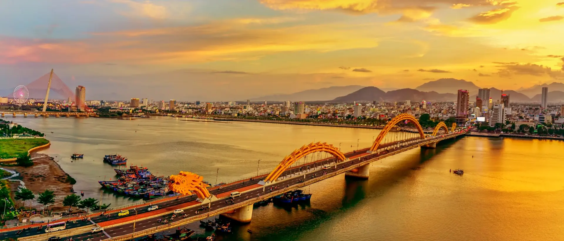 View of a 2,185-foot-long bridge shaped like an undulating golden dragon is the most famous bridge over the Han River in downtown Danang