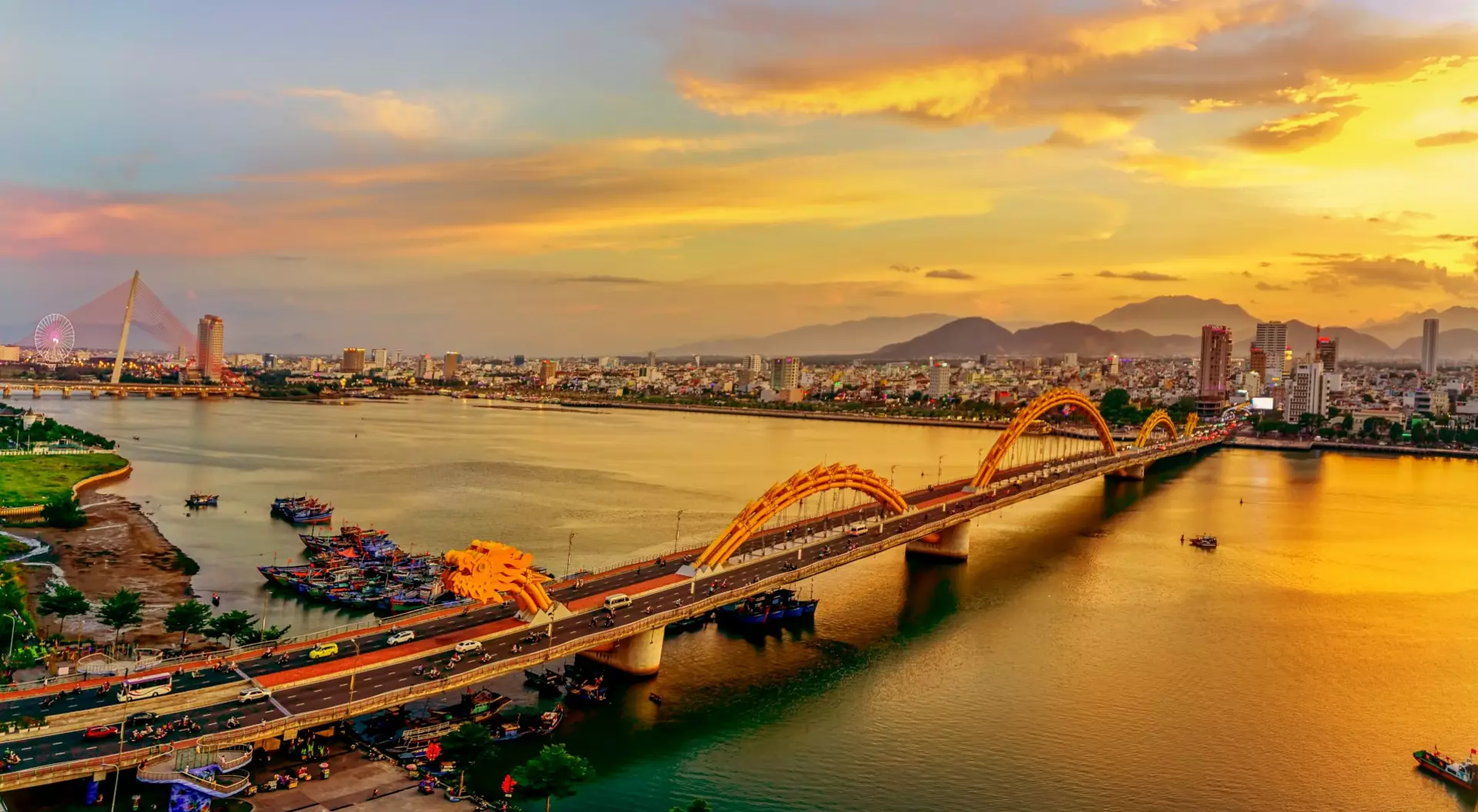 View of a 2,185-foot-long bridge shaped like an undulating golden dragon is the most famous bridge over the Han River in downtown Danang