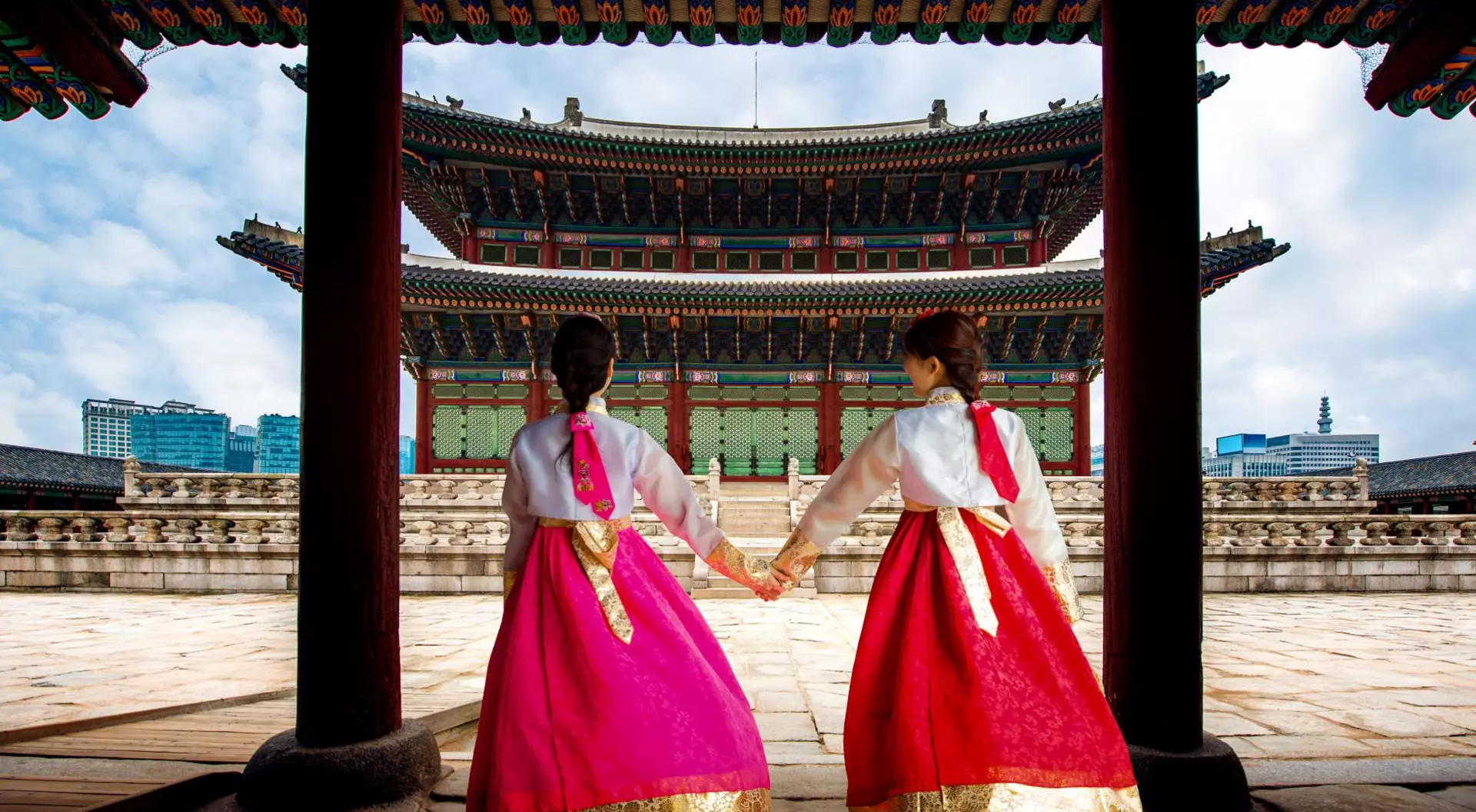 Korean women in Hanbok or Korean Gress, walking at Gyeongbokgung Palace in Seoul, South Korea