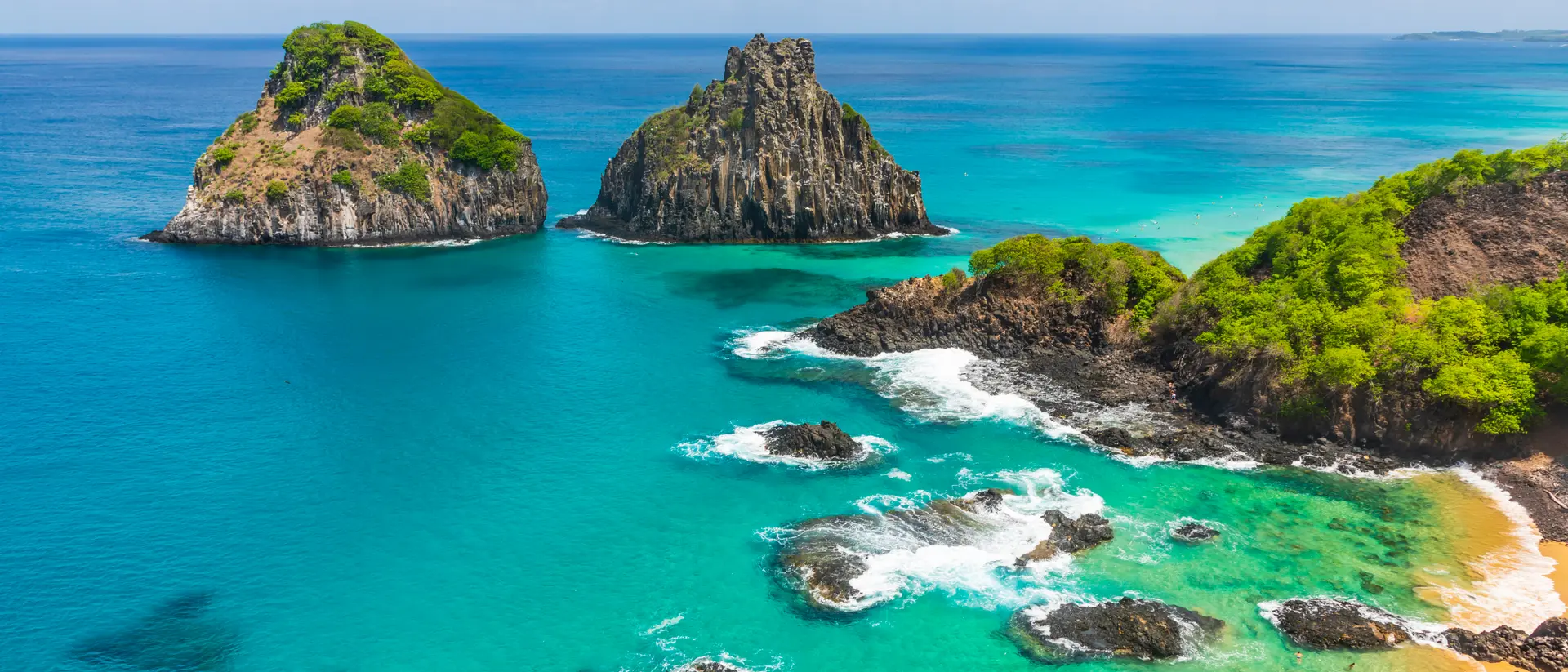 Aerial view of tropical island coastline with beautiful waters