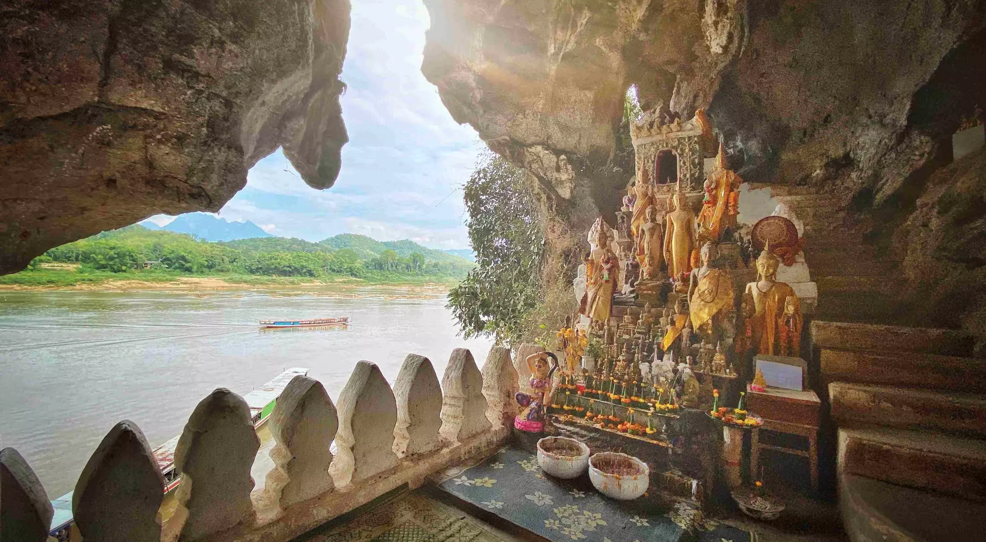 Sunbeam into the Pak Ou Cave Buddha Shrine at Tham Ting Buddhist Cave. Mekong River, Luang Prabang, Laos