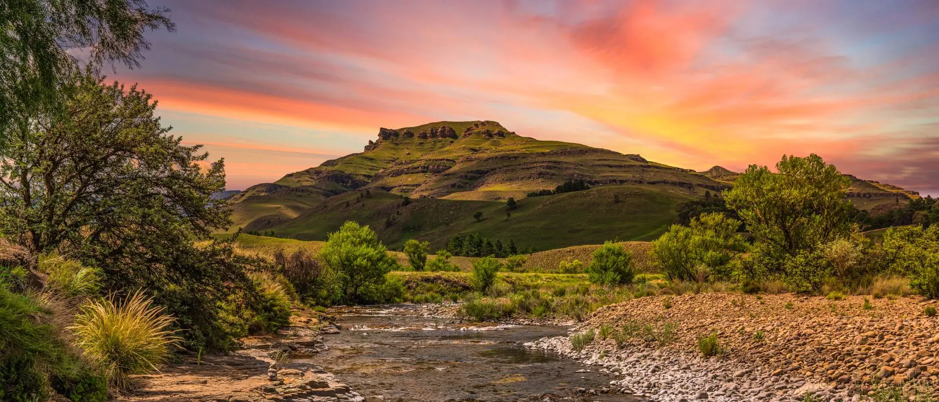Drakensberg Valley Drakensberg valley and a river running through it during sunset