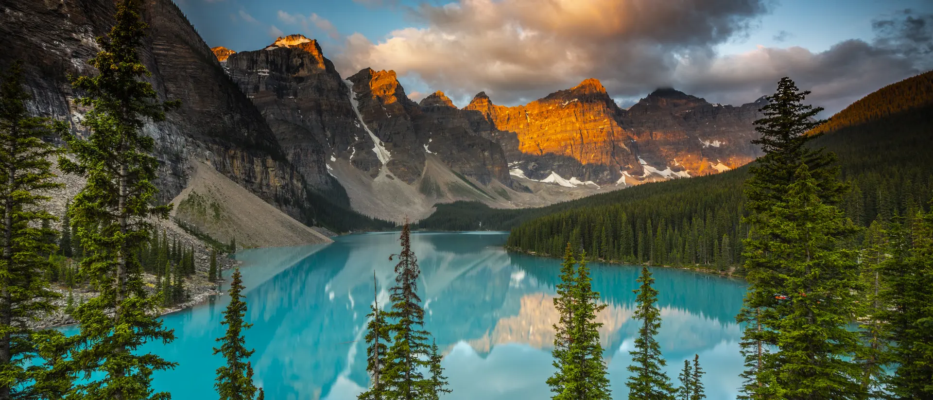 Banff National Park, Alberta, Canada Moraine Lake in Banff National Park at sunset. Mountains of famous Ten Peaks reflecting in the beautiful calm turquoise water of the lake
