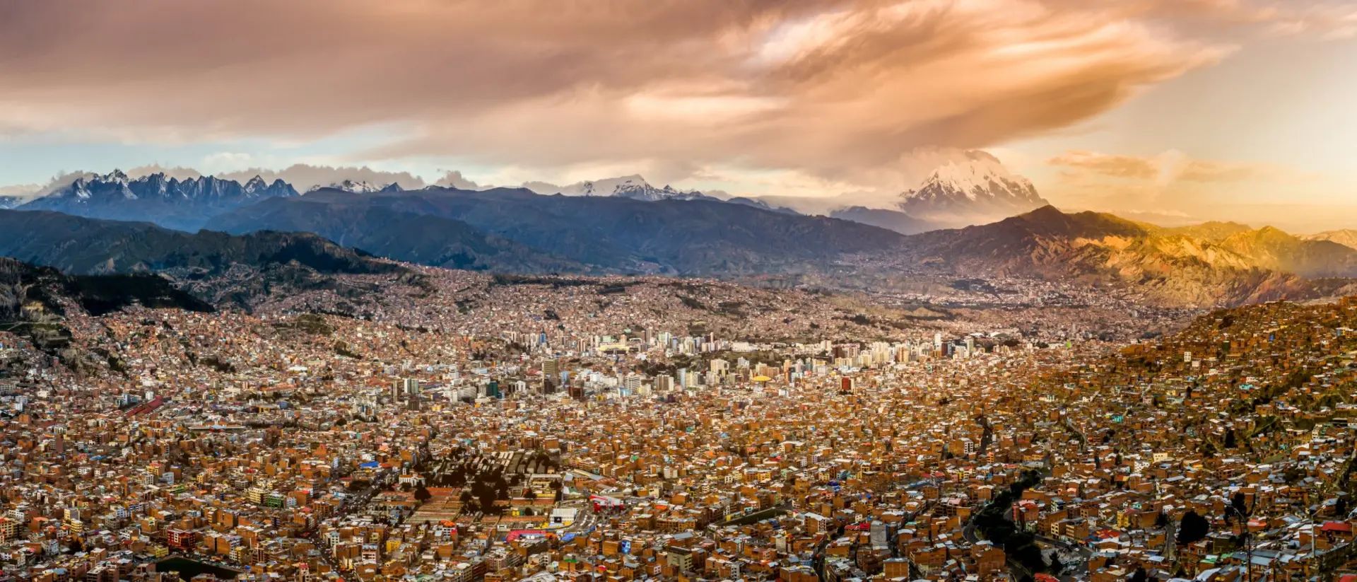 Panoramic view of La Paz, Bolivia, during sunset with Illimani Mountain rising in the background