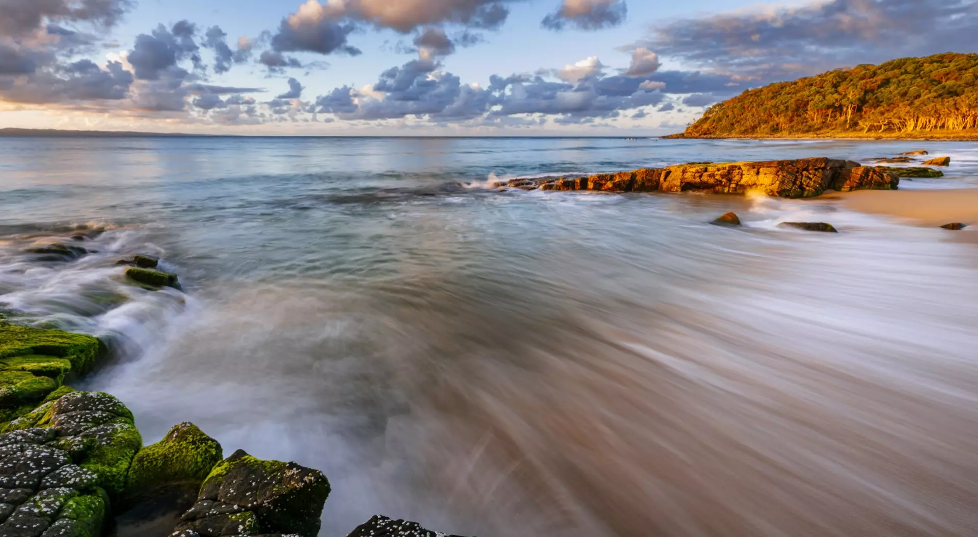 Sunshine Coast Water crests the shoreline at sunset