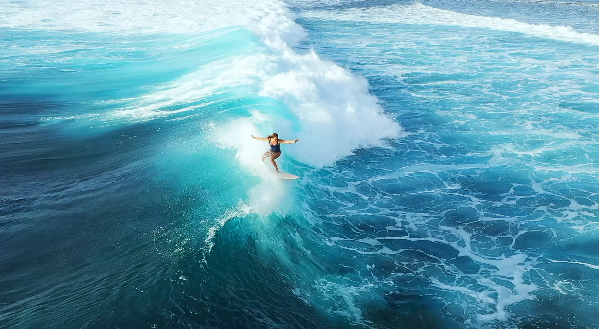 Lagoon in Maldives Surfer woman riding on the blue ocean