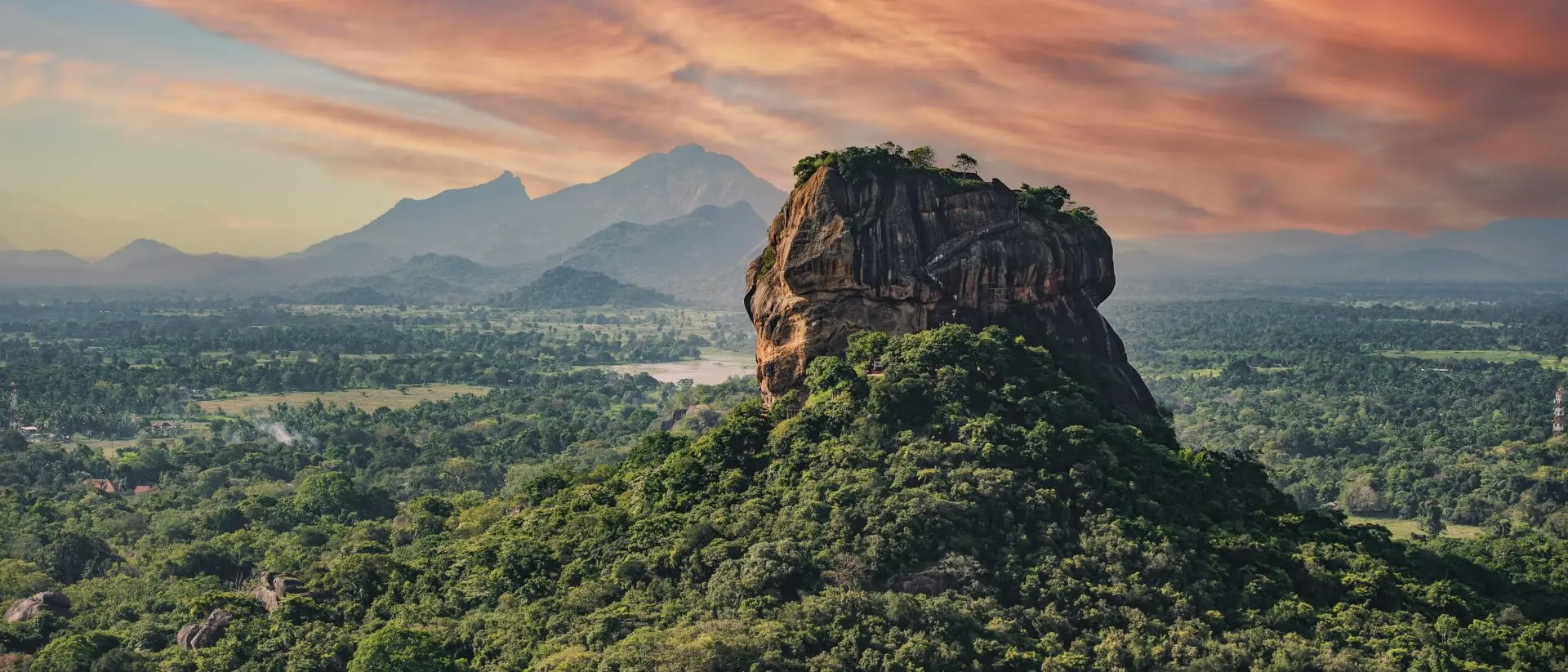 "View of the Lion rock surrounded by green rich vegetation, photo taken from Pidurangala Rock in Sigiriya, Sri Lanka."