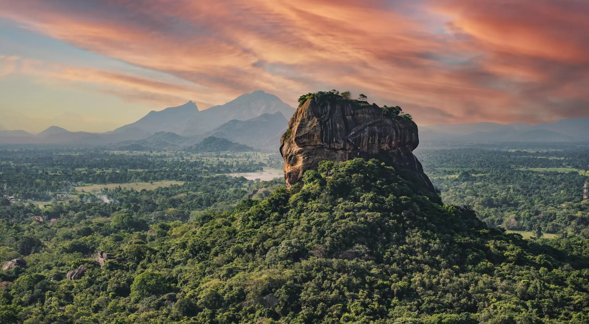 "View of the Lion rock surrounded by green rich vegetation, photo taken from Pidurangala Rock in Sigiriya, Sri Lanka."