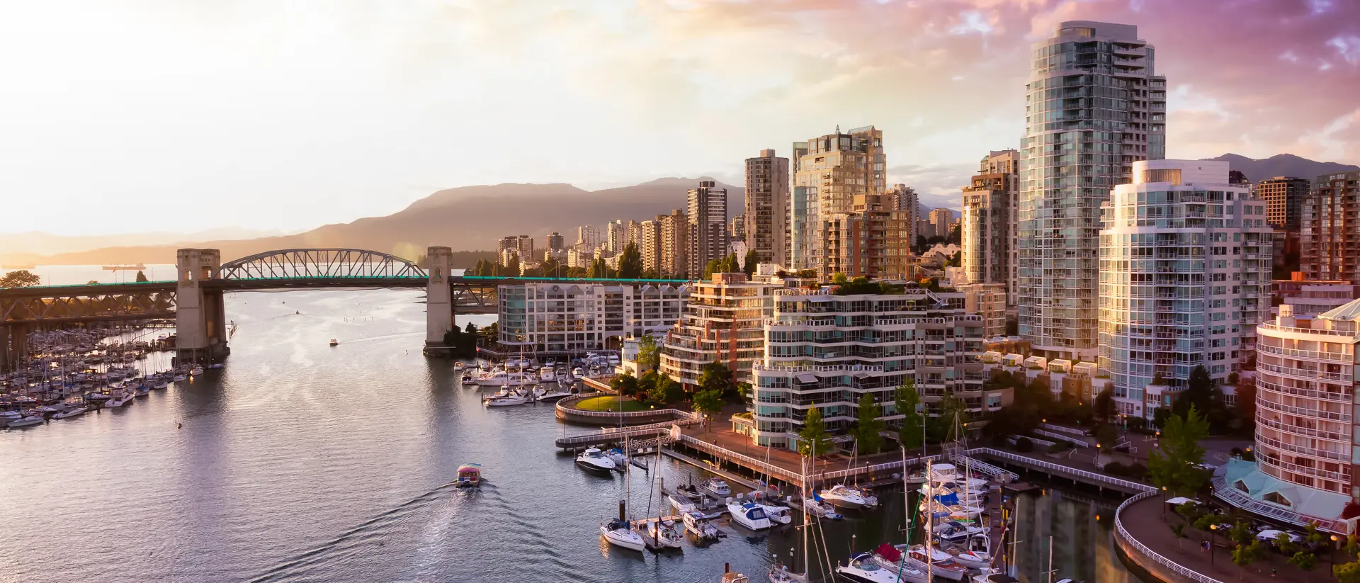 iew of Burrard Bridge and False Creek in downtown, taken during a beautiful cloudy sunset.
