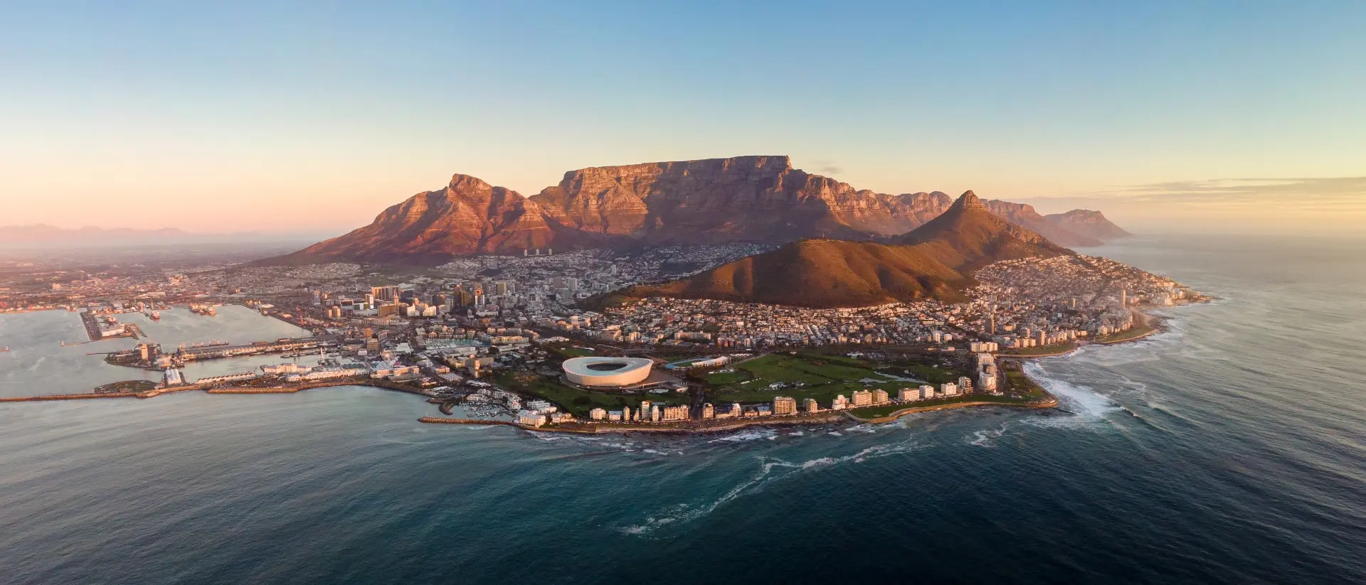 Aerial panoramic view of Cape Town cityscape at sunset, Western Cape Province, South Africa.