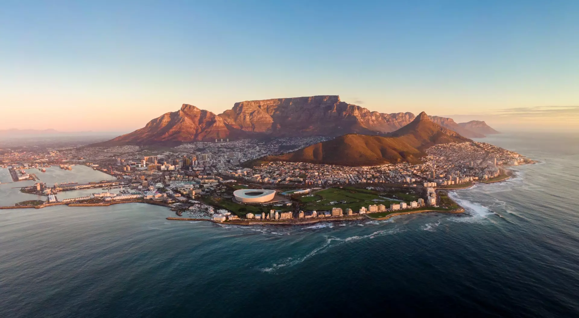 Aerial panoramic view of Cape Town cityscape at sunset, Western Cape Province, South Africa.