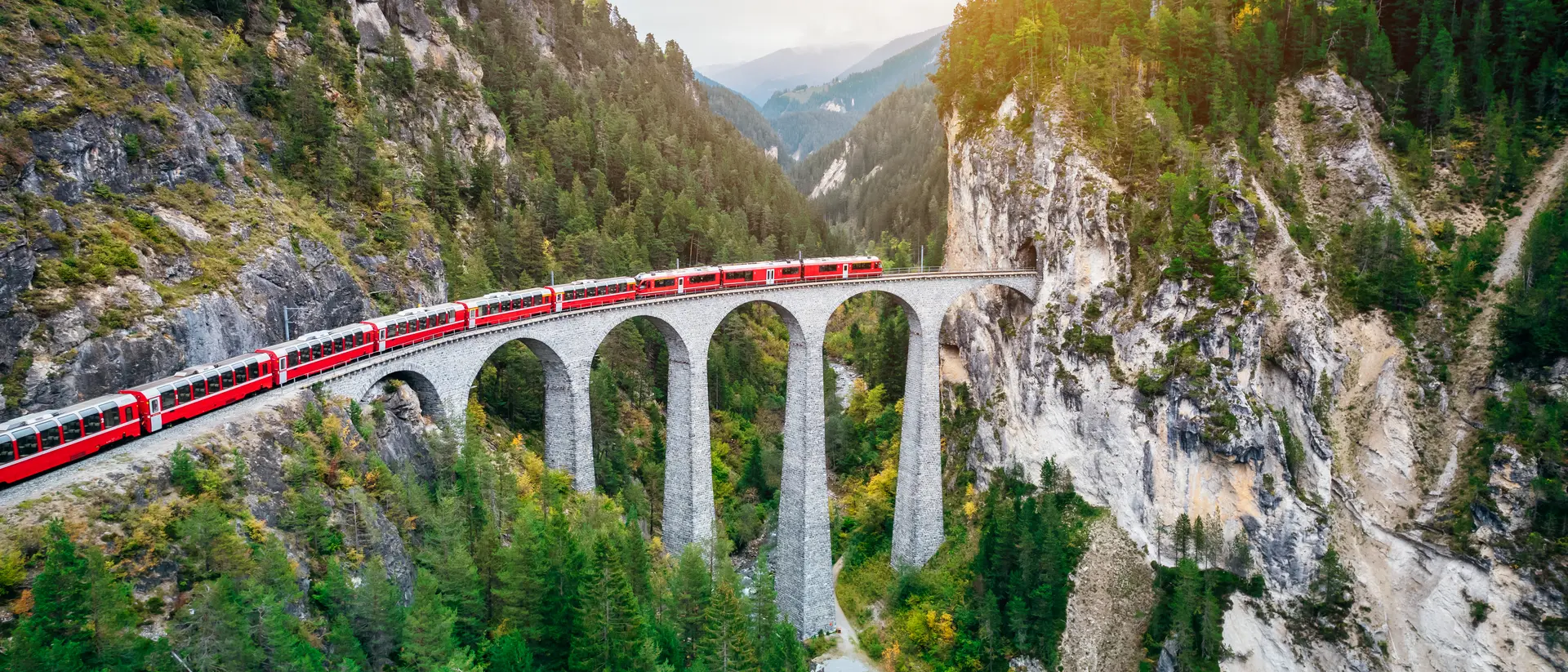 Train crossing Landwasser Viaduct on raethian railway in Filisur – Albula, Graubunden, Switzerland 