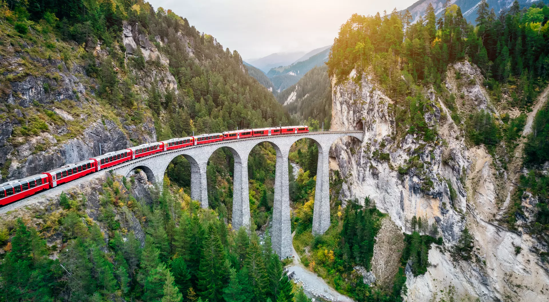Train crossing Landwasser Viaduct on raethian railway in Filisur – Albula, Graubunden, Switzerland 