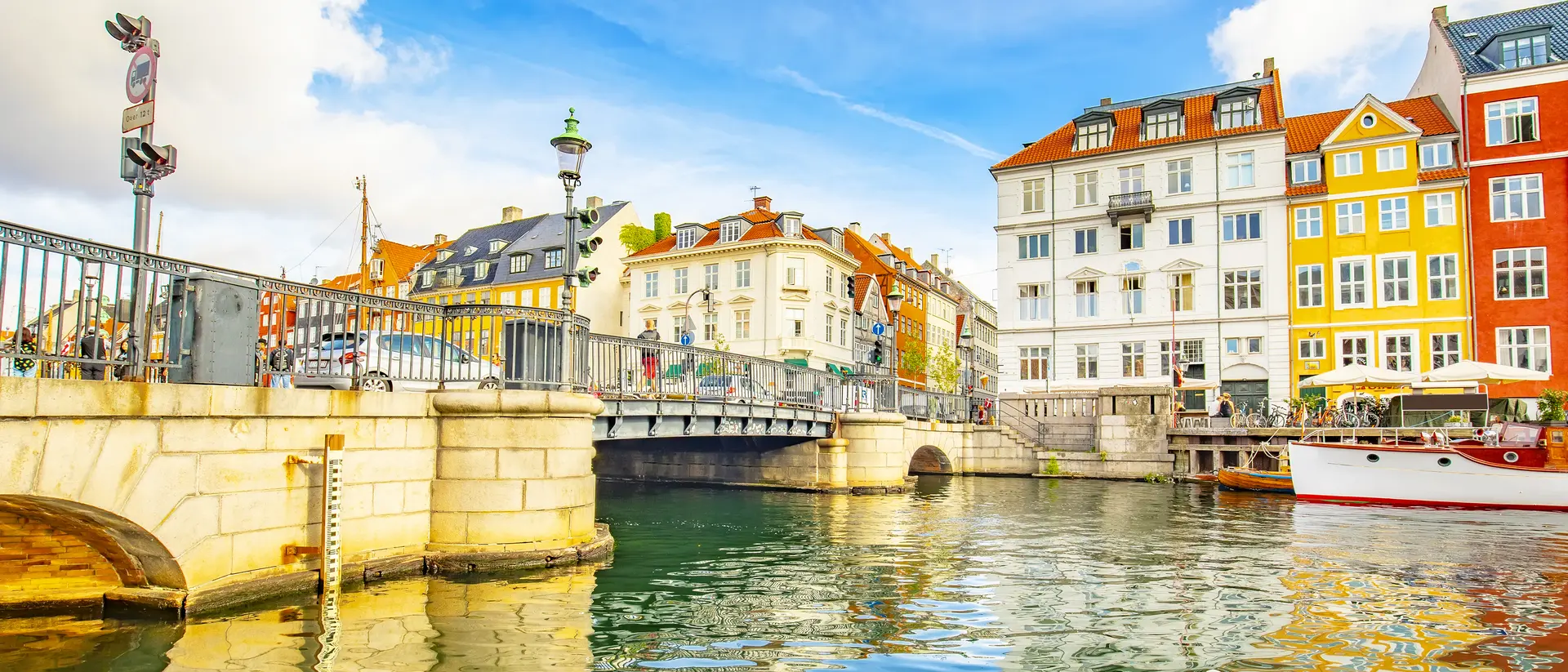 Coloful houses sit on the canal of the old town skyline in Copenhagen