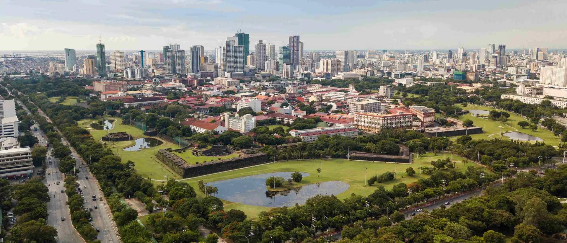 Intramuros, Manila Aerial of Intramuros, an old historic walled city, surrounded by golf courses, and Manila skyline in background