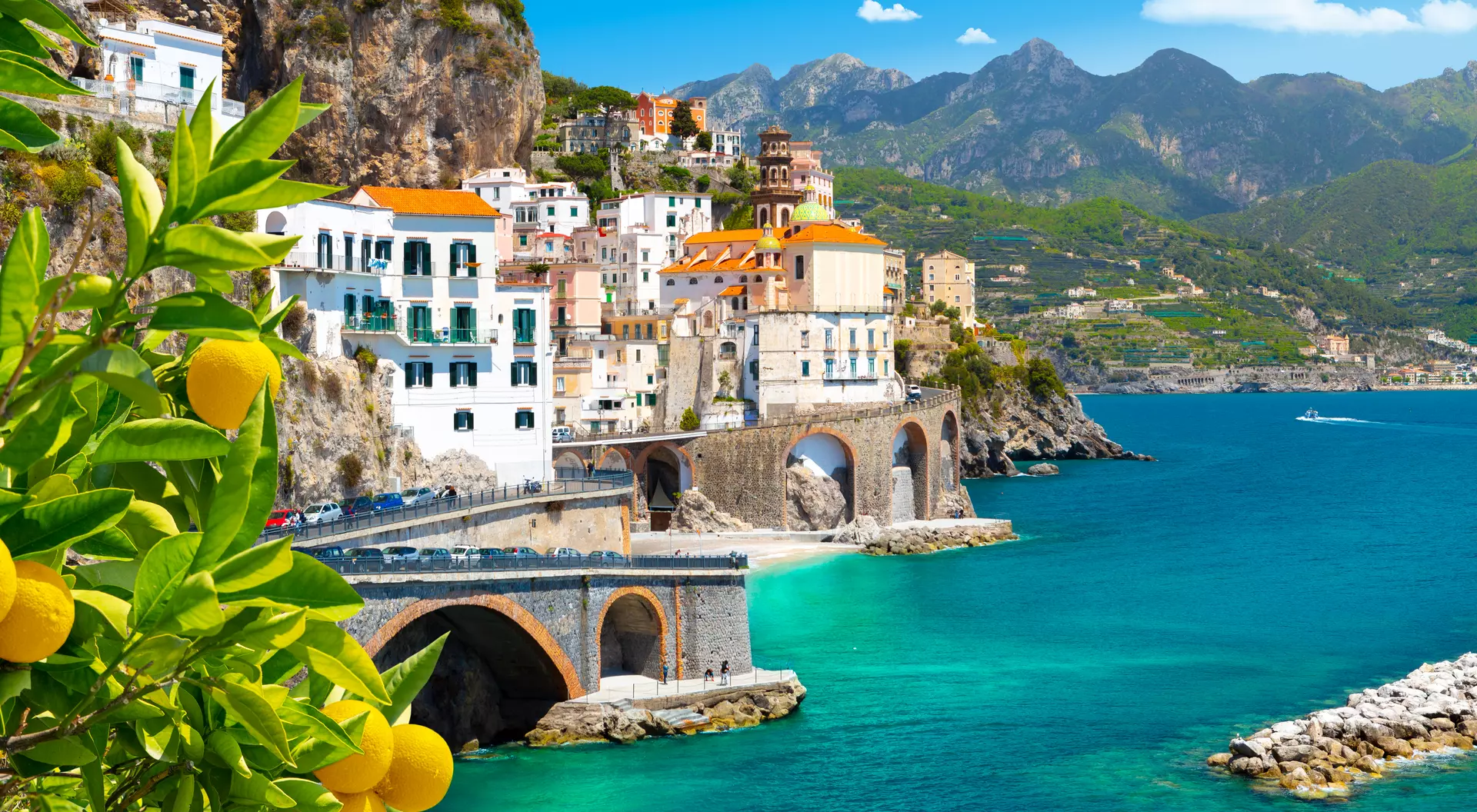 Beautiful view of Amalfi on the Mediterranean coast with lemons in the foreground