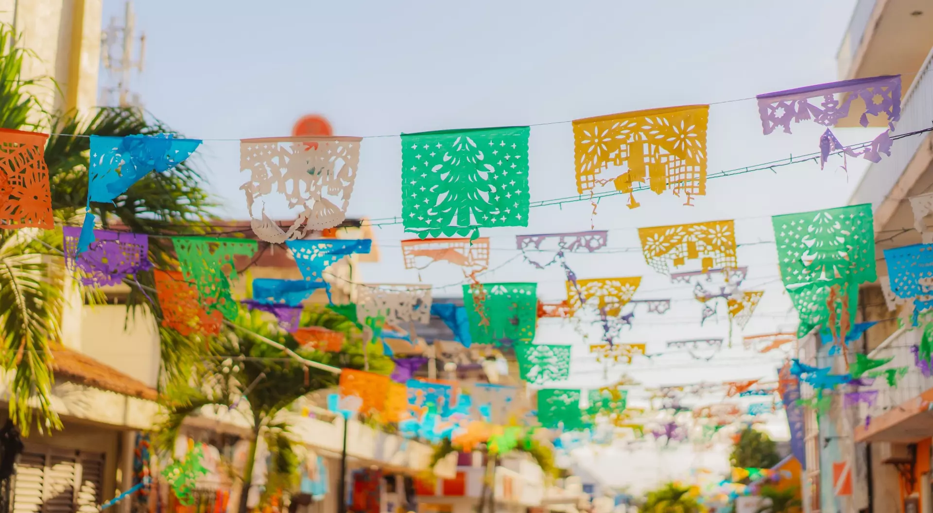 Colourful flags are waving on a shopping street in Mexico