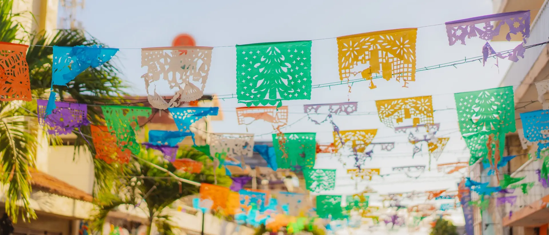 Colourful flags are waving on a shopping street in Mexico