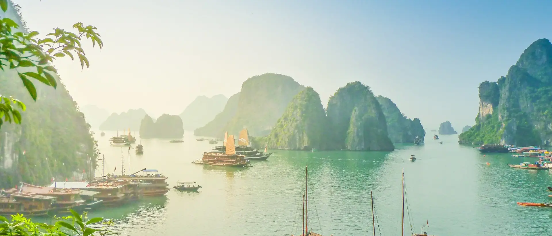 Aerial view of junk boat crusie during sunse near Rock Island, Ha Long Bay, Vietnam. UNESCO World Heritage Site