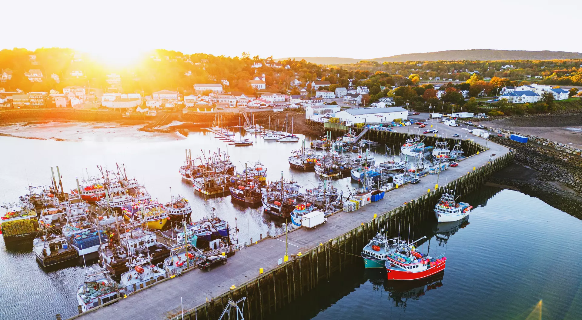 Fisherman's Cove, Nova Scotia Aerial drone view of a small town fishing wharf just before sunset.