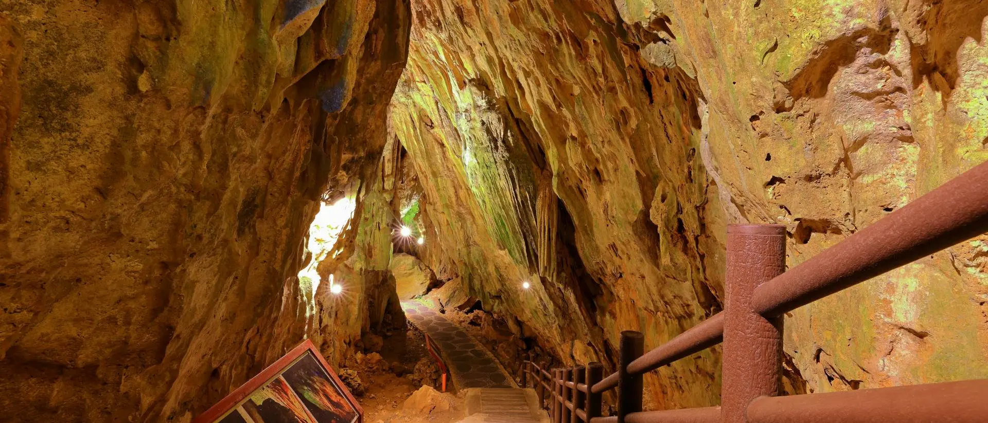Stairs descend underneath natural rock and caves