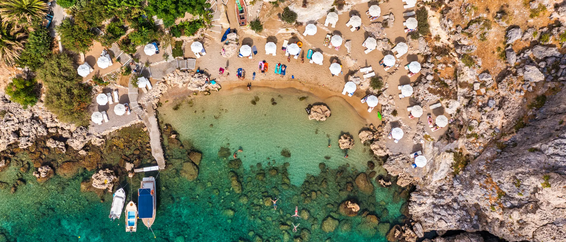 Aerial photo of beach goes and boats in the bay
