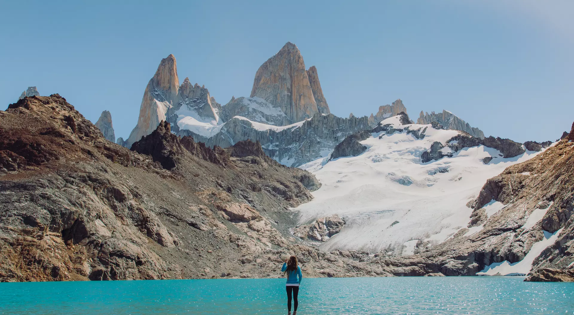 Mount Fitz Roy, Patagonia Female explorer hiking to the turquoise glacial lagoon with view of Mount Fitz Roy in El Chalten, Argentina