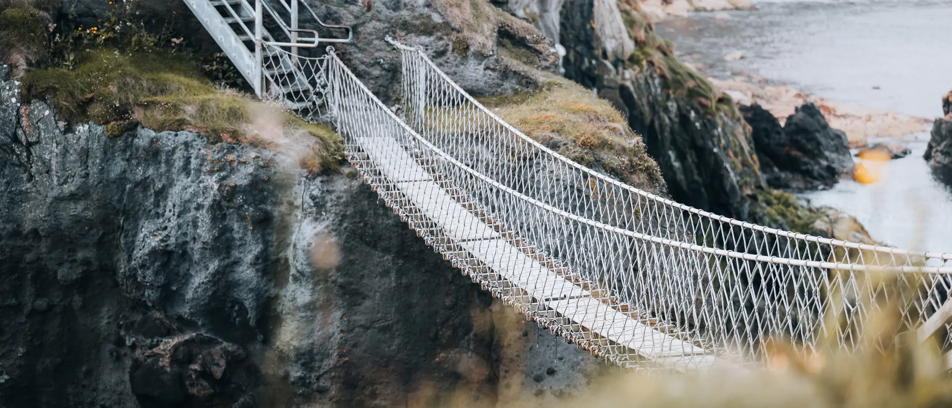 Discover Carrick-a-Rede Island in County Antrim via a rope bridge suspended above the Atlantic Oceann