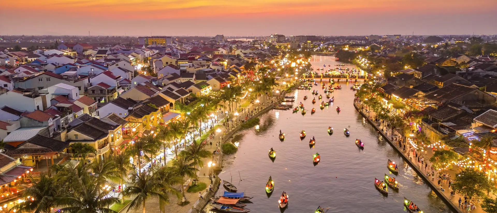 Thu Bon River Hoi An at dusk with boats cruising on Thu Bon River with lanterns