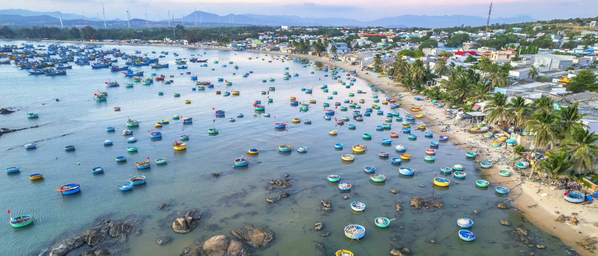 "Aerial view of Mui Ne fishing village in the morning with hundreds of boats anchored to avoid storms"