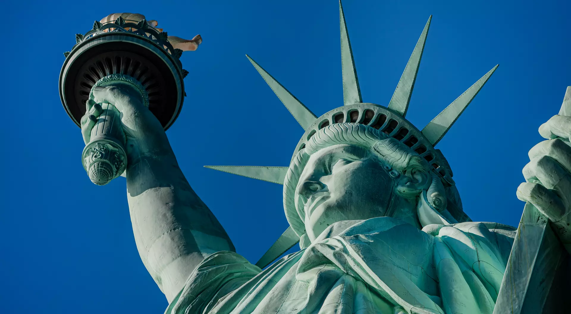 New York Statue of Liberty in a blue summer sky. Landmark of New York Blue sky