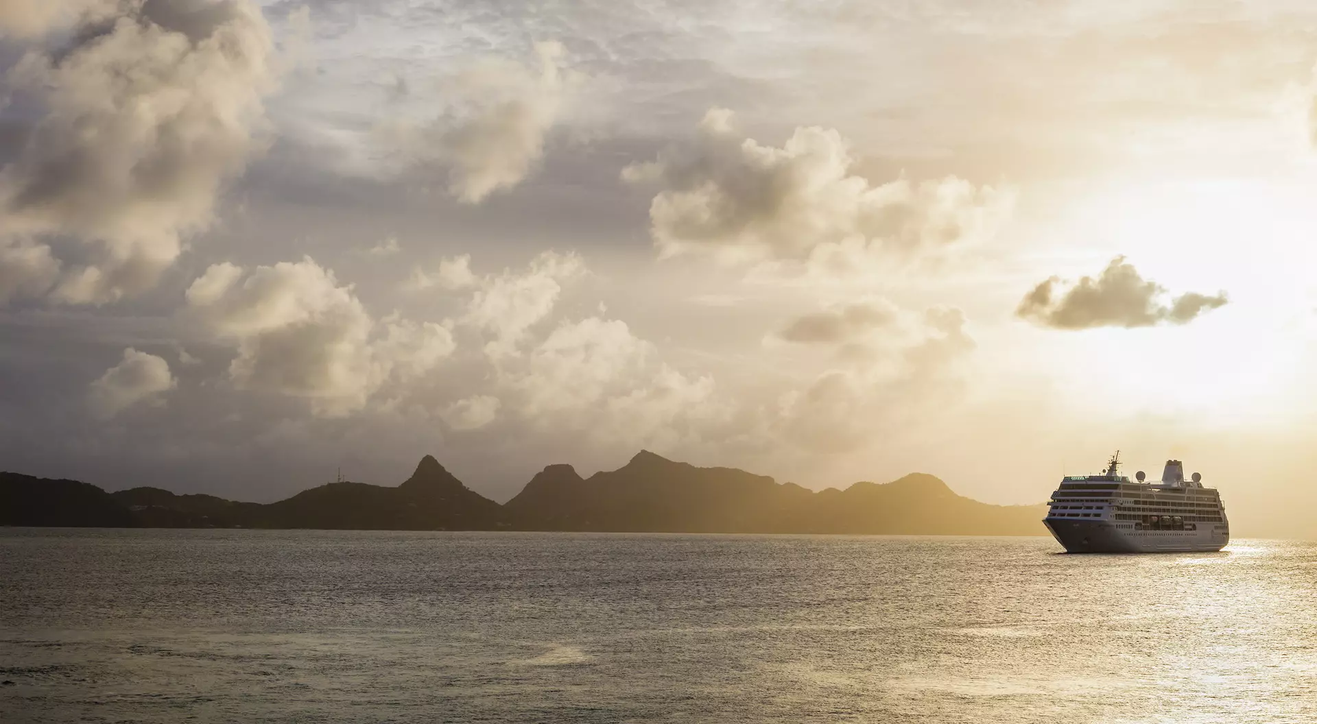 Cruise ship moored off Mayreau Island, one of the Grenadines. The island in the background is Union Island.