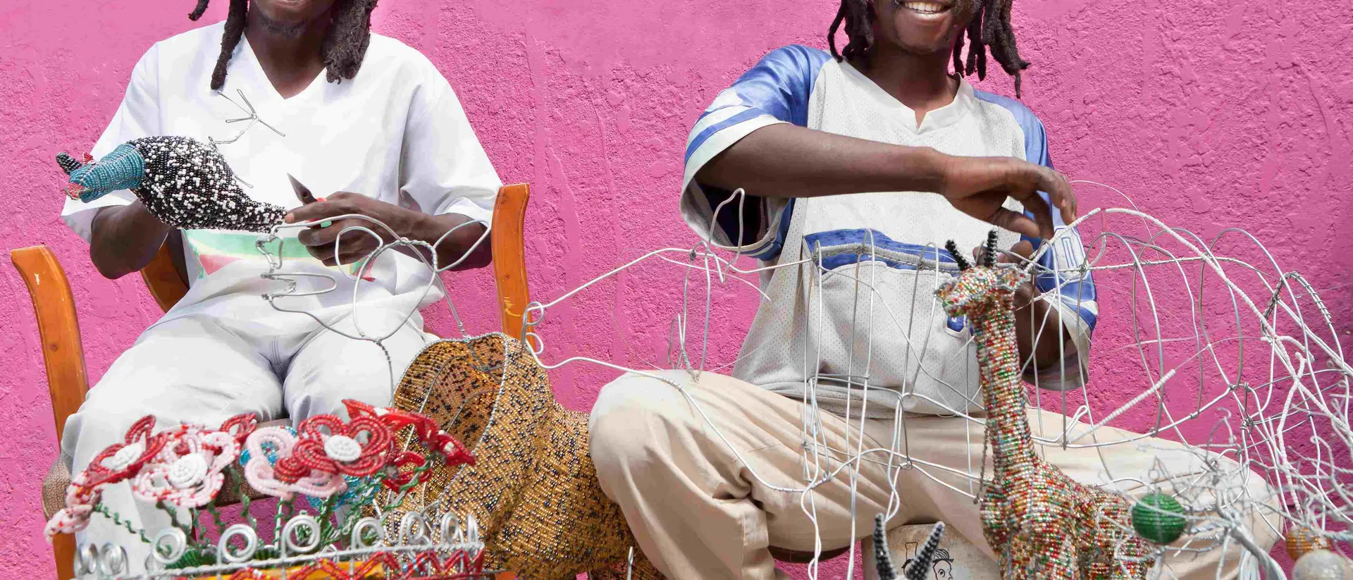 Zimbabwe African men working outdoors designing, producing and selling beadwork, directly to the public