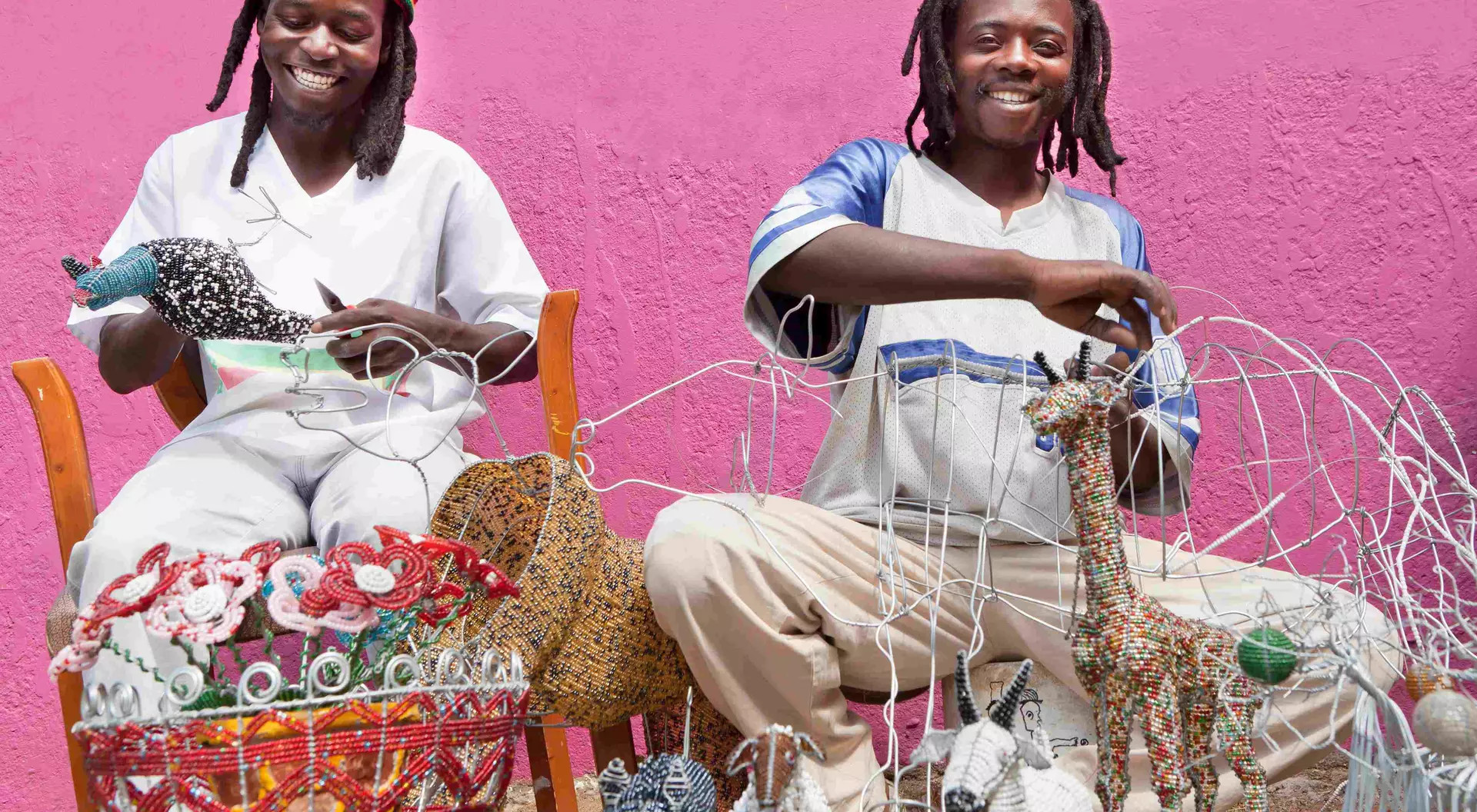 Zimbabwe African men working outdoors designing, producing and selling beadwork, directly to the public