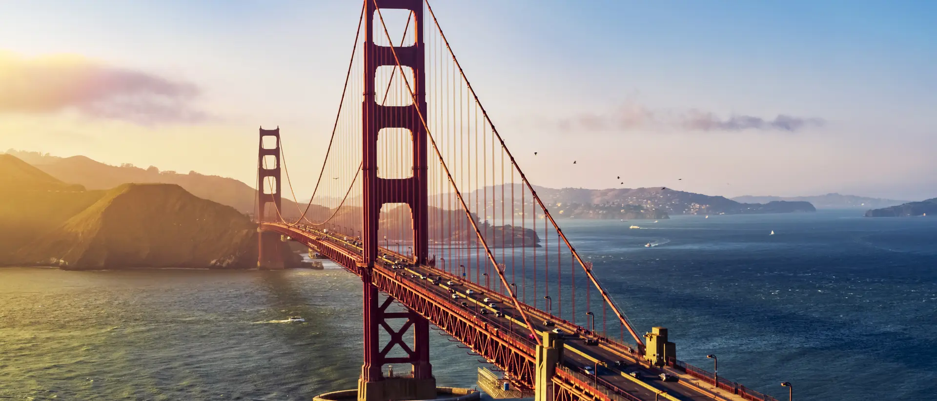 California Aerial view of traffic moving on Golden Gate Bridge during sunset