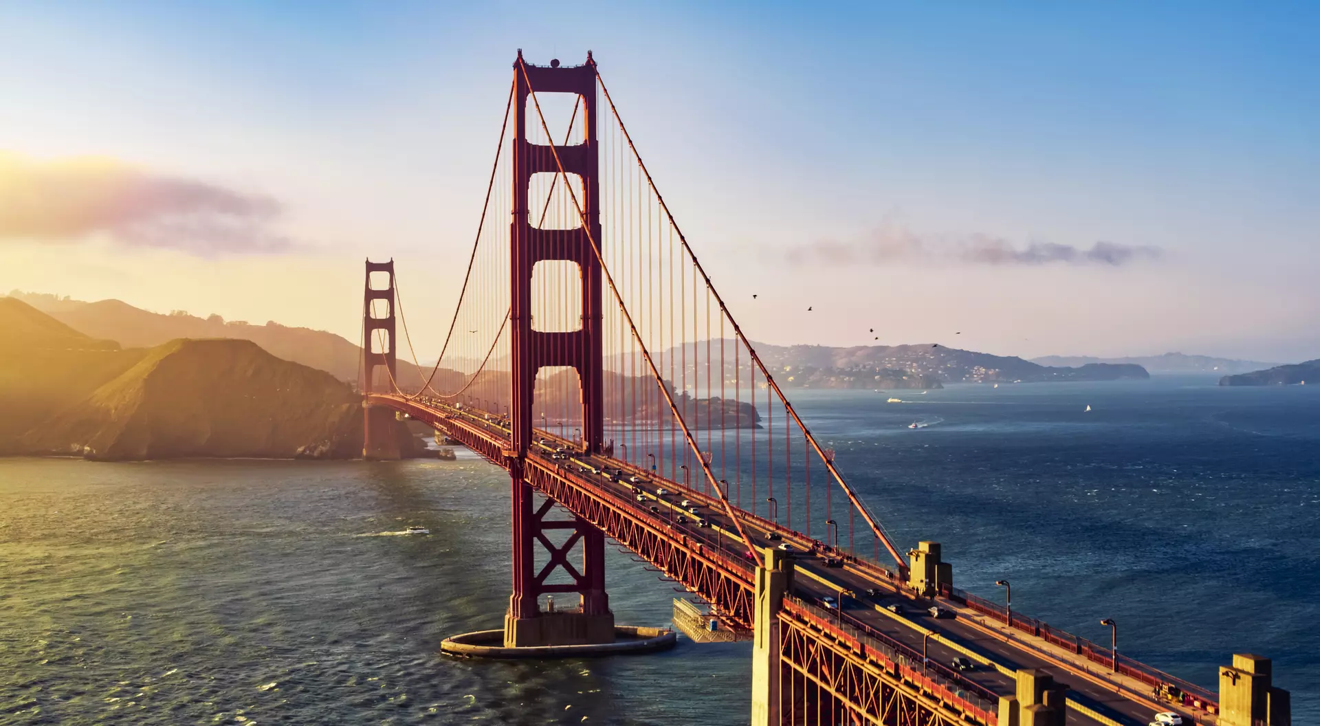 California Aerial view of traffic moving on Golden Gate Bridge during sunset