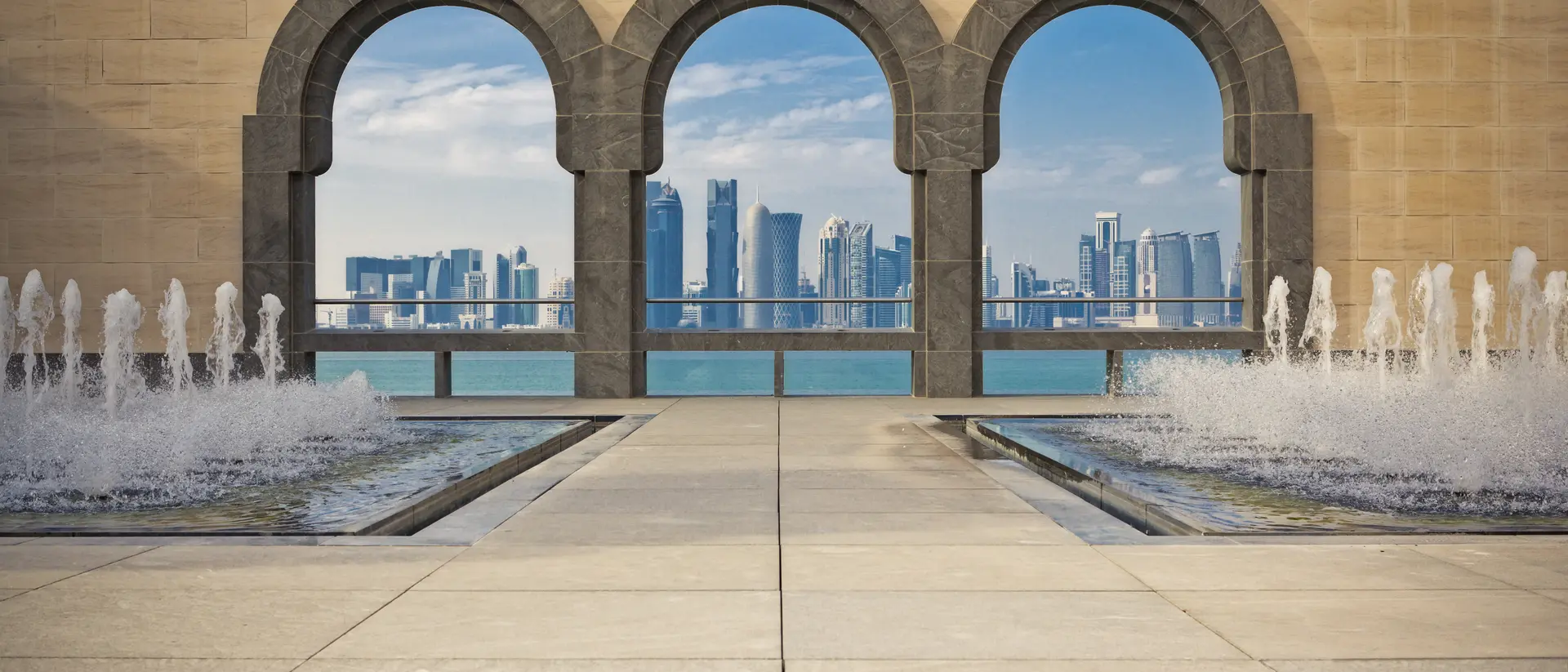 The Museum of Islamic Art Doha Skyline framed by the patio arches of the Museum of Islamic Art