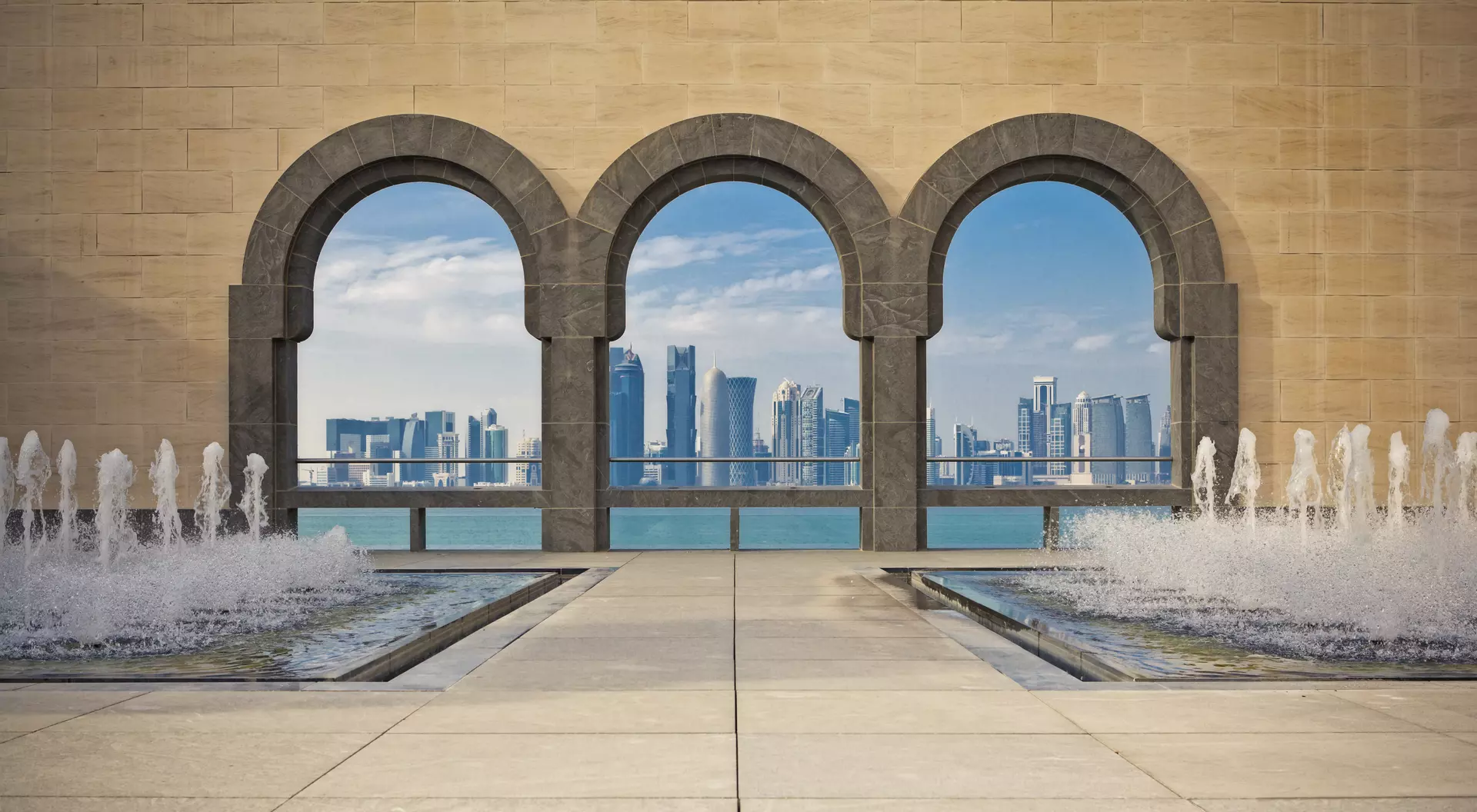 The Museum of Islamic Art Doha Skyline framed by the patio arches of the Museum of Islamic Art