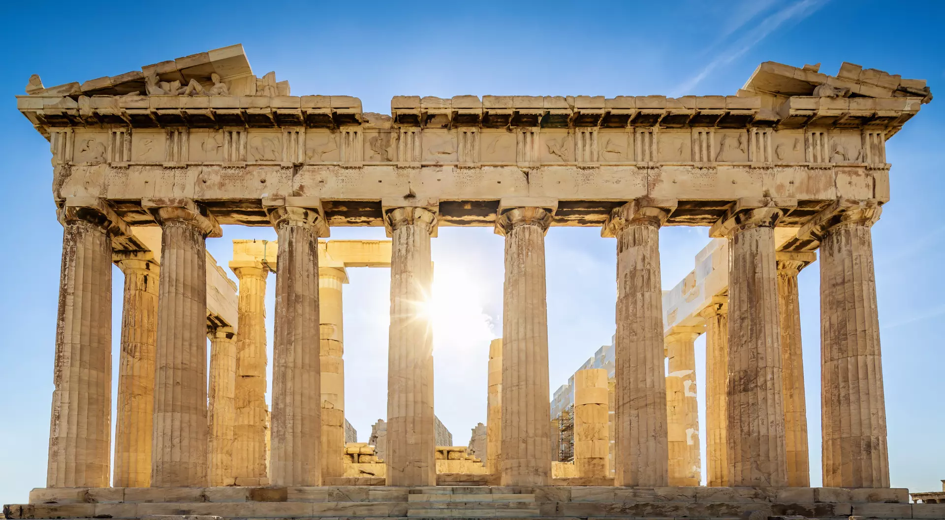 Greece The Parthenon on the Athenian Acropolis, Sun shining through the columns. The Temple is dedicated to the Greek Goddess Athena.