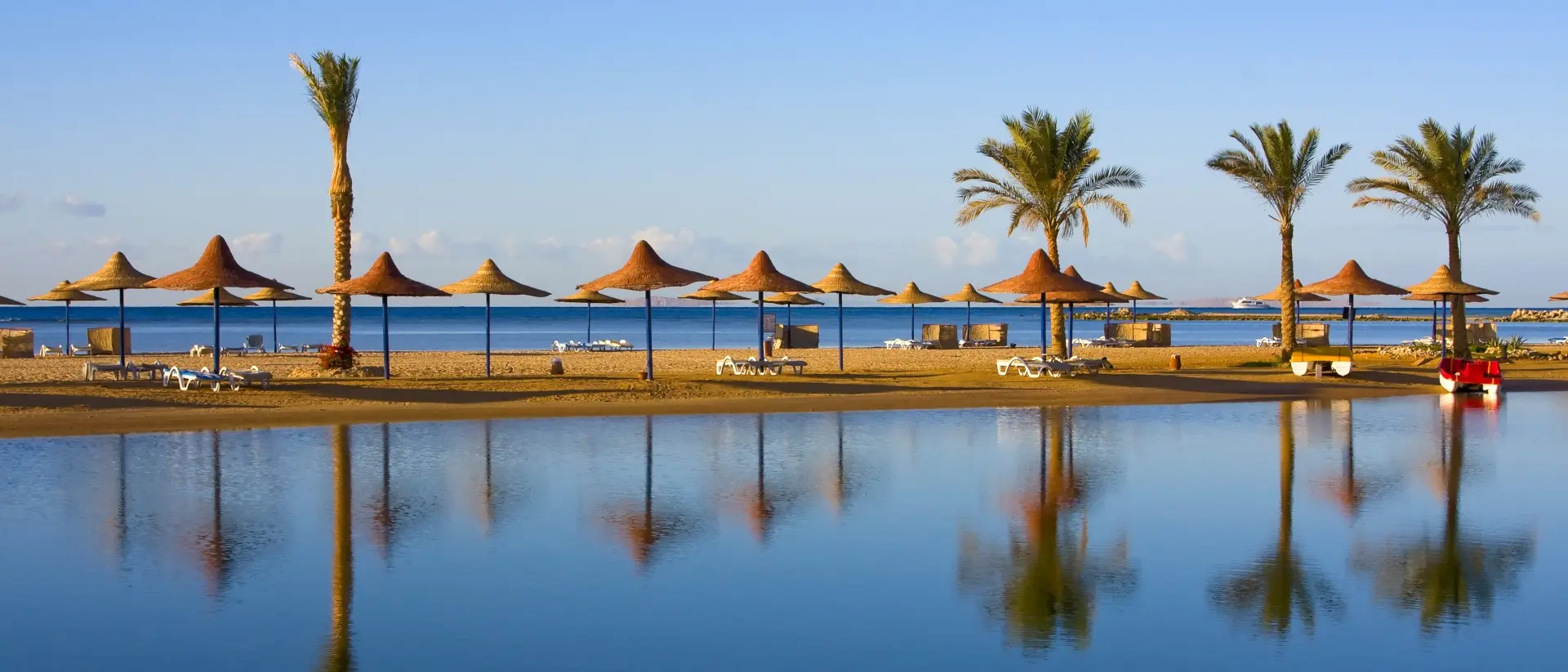 Straw umbrella on the beach, provides a perfect shady retreat amidst golden sands and crystal-clear waters.